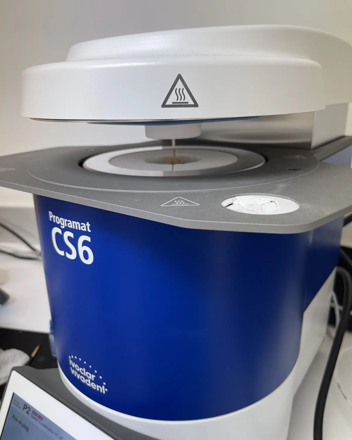 Horno de cerámica (Ivoclar Programat CS6) con una corona dental en la cámara de cocción, en la clínica Rosado Dental